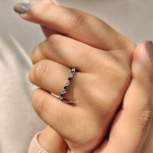 Shared prong setting on a stunning emerald diamond wedding band.
