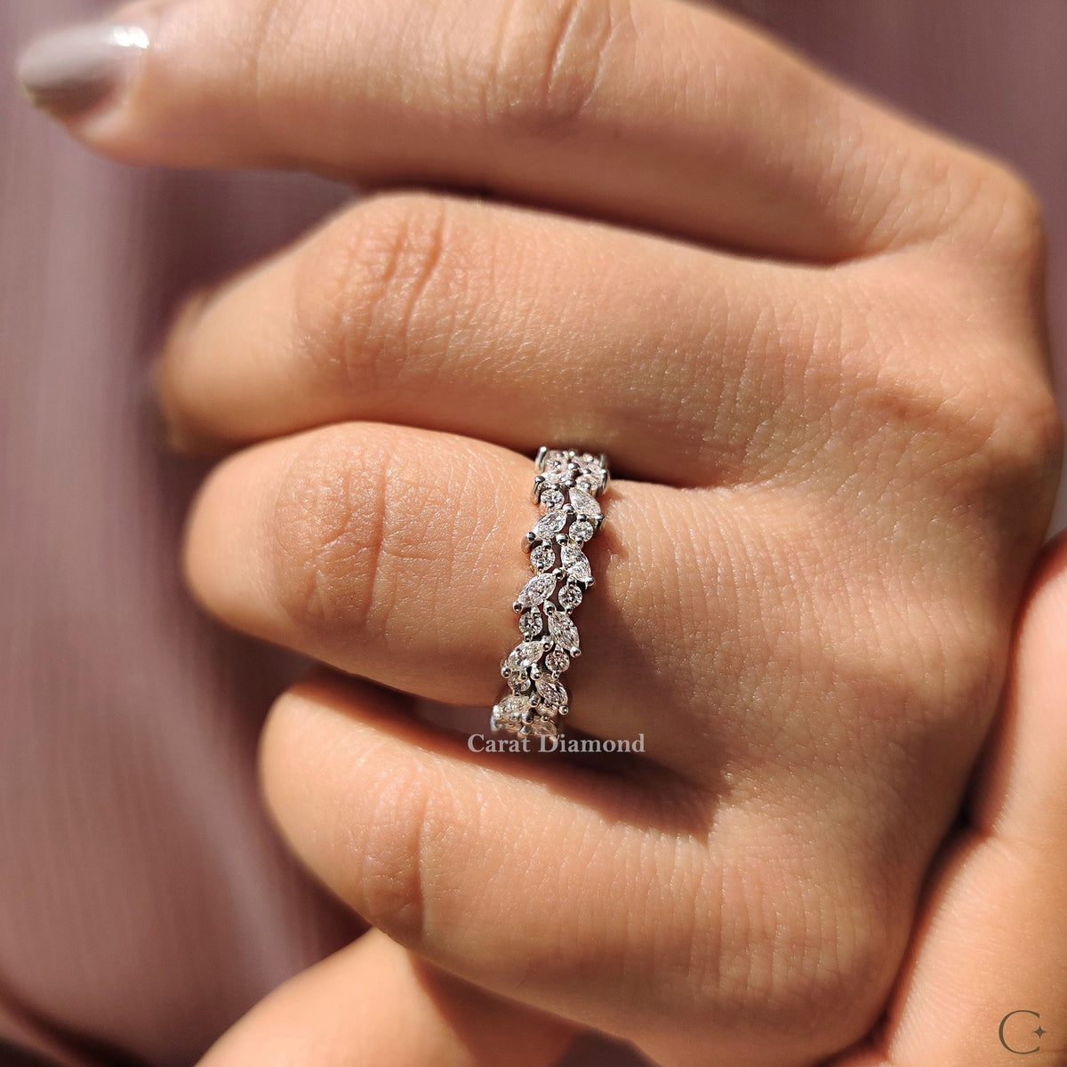 White gold wedding band with elegant diamond design.
