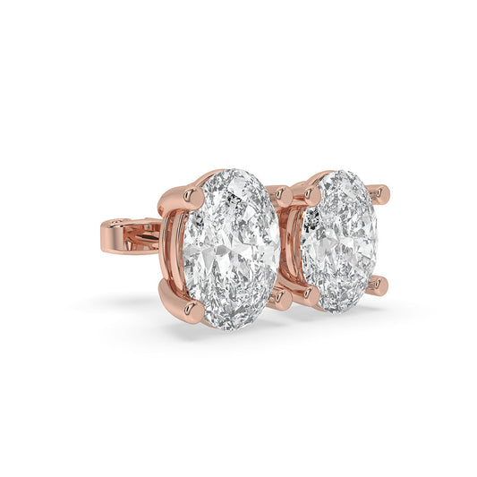 Diamond solitaire earrings designed as elegant gold stud earrings.