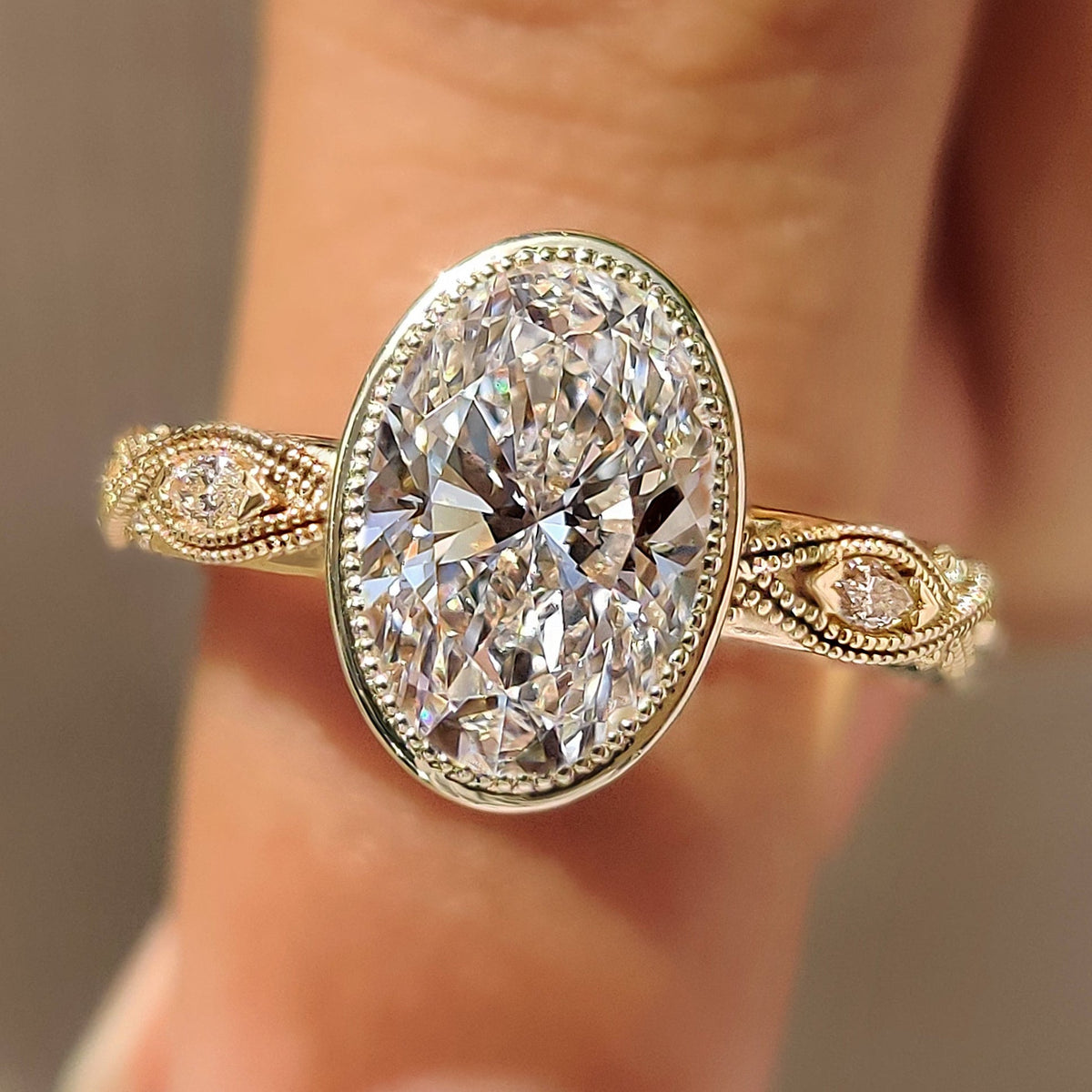 Bezel engagement ring with oval center diamond
