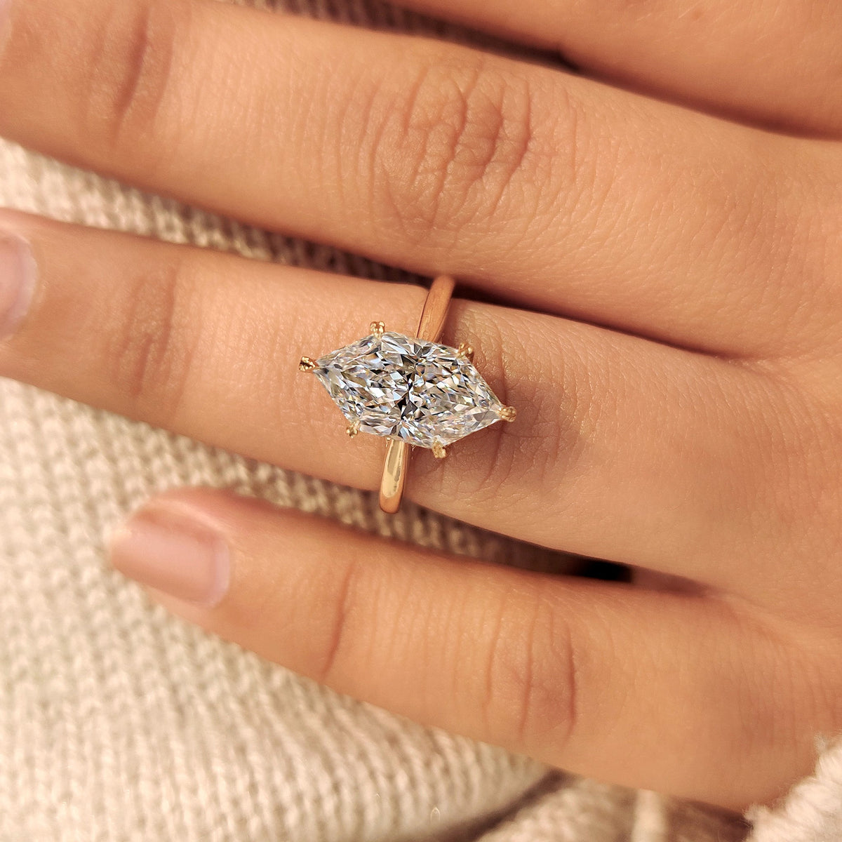 Solitaire dutch marquise engagement ring with hidden halo.