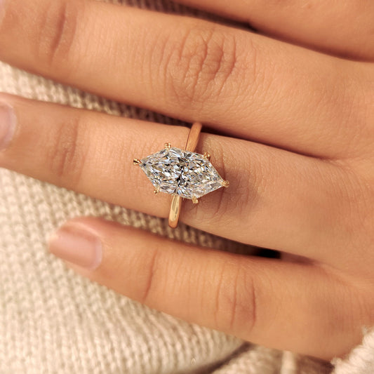 Solitaire dutch marquise engagement ring with hidden halo.