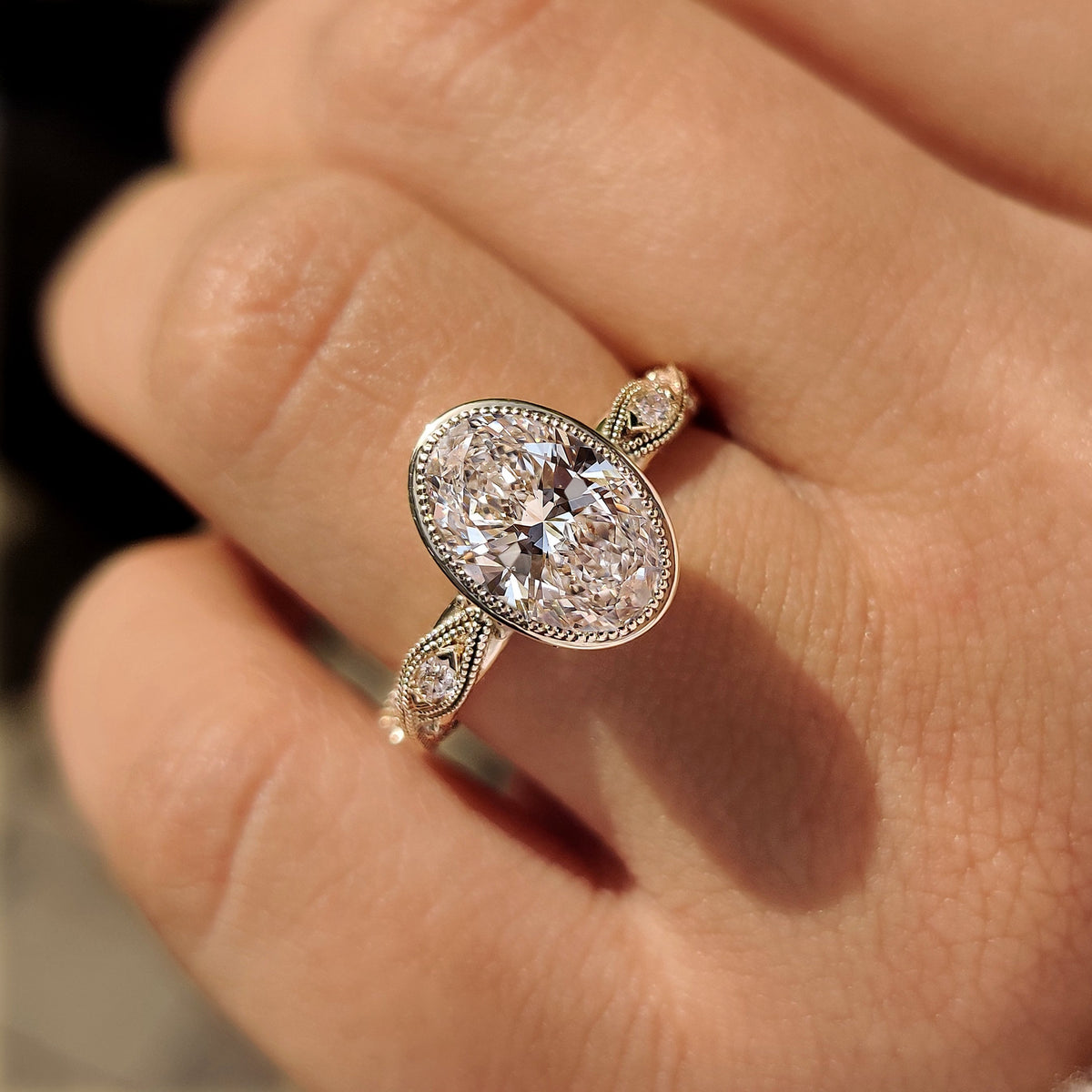 Bezel ring with oval center diamond