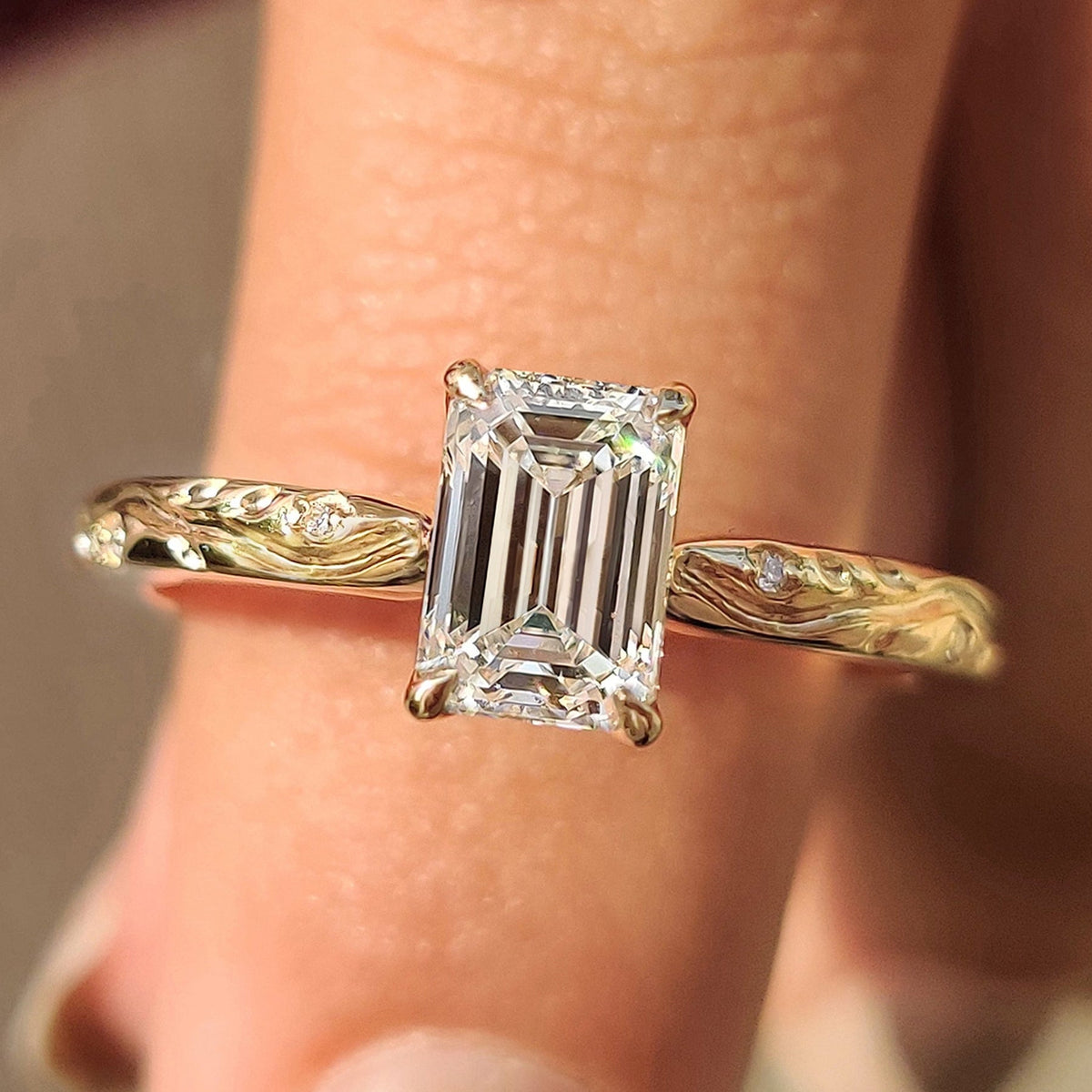Round side stone ring with an emerald cut center.
