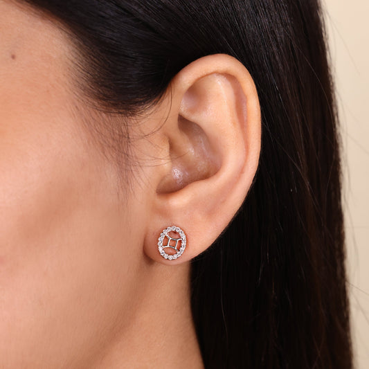 Custom Gemini zodiac earrings in rose gold with halo diamonds.
