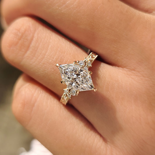Nature inspired diamond ring with floral design and milgrain.