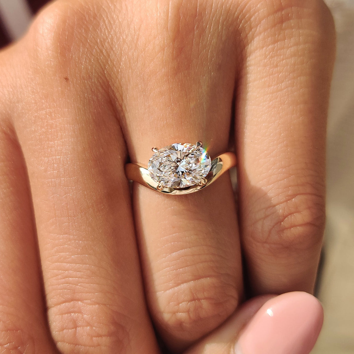 Pinky style oval cut diamond ring with four claw prong
