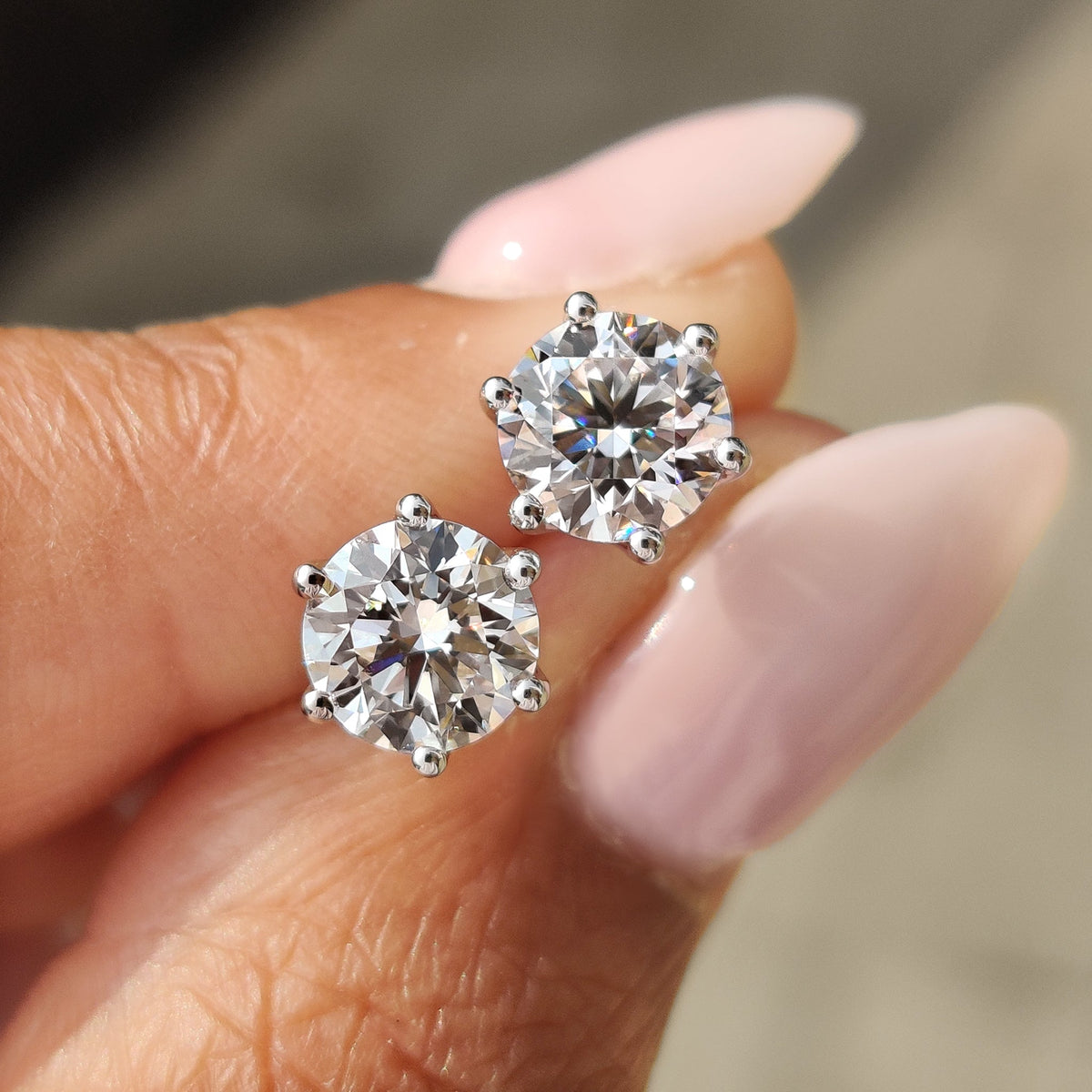 Round cut diamond earrings sparkling in white gold.