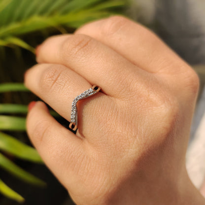 Curved wedding band in white gold with a sleek design.