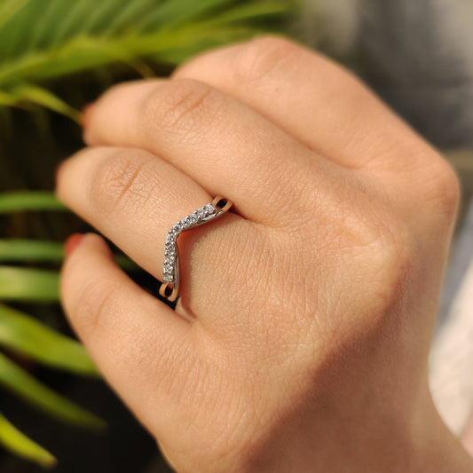Curved wedding band in white gold with a sleek design.