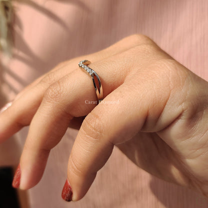 Round cut diamond wedding band with a curved fit.