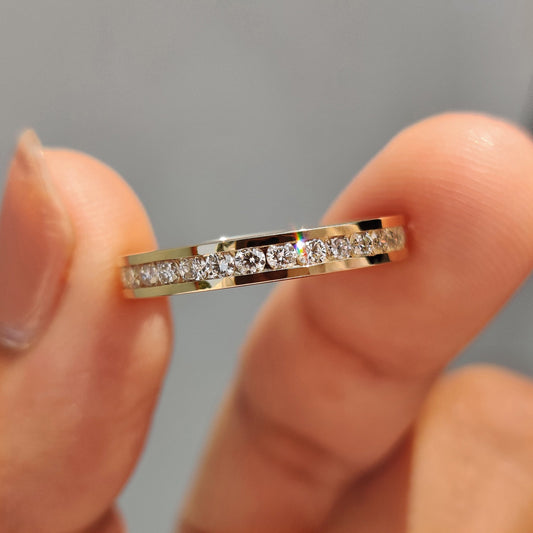 Channel set diamond band featuring a round diamond wedding band.