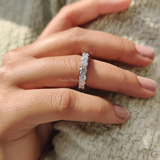 Round diamond wedding band worn on a bride's finger.