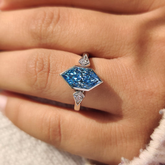 Three stone engagement ring with kite side stones