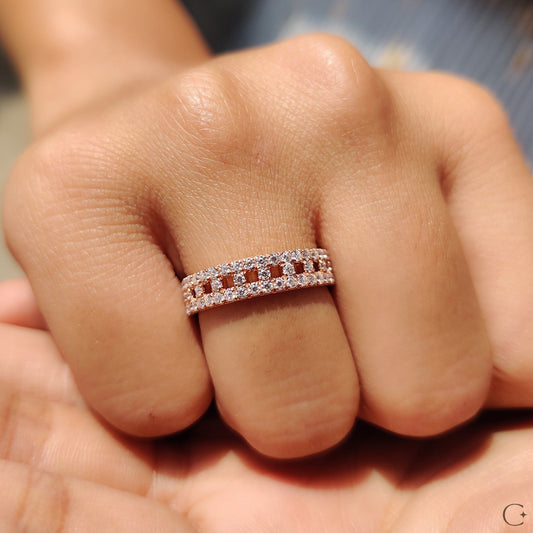 Classic wedding band resting on a velvet fabric surface.