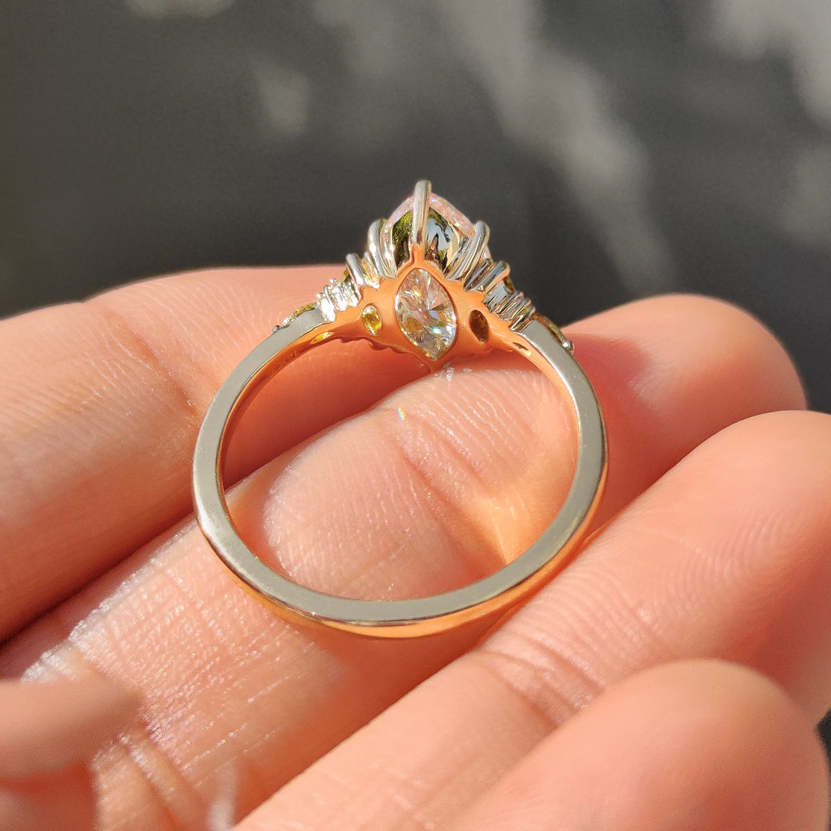 Carat diamonds marquise ring with detailed side stones.