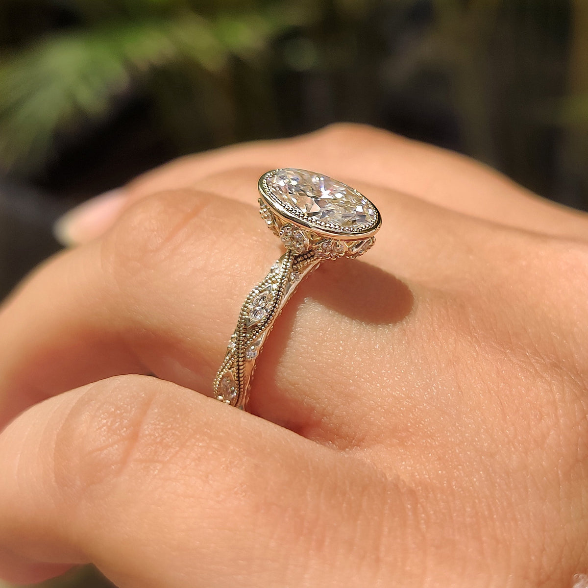 Bezel ring with marquise and round side stones