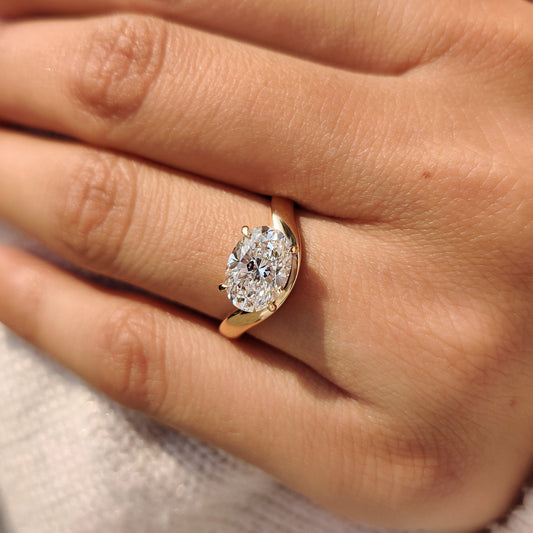 Carat Diamonds oval cut diamond ring in pinky style
