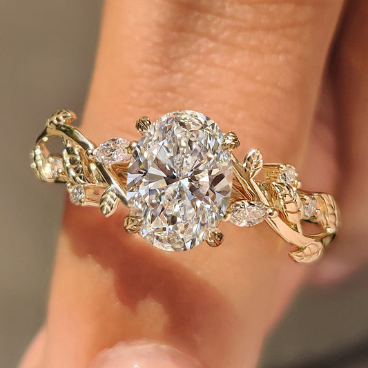 Oval diamond ring with leaf and vine inspired details.