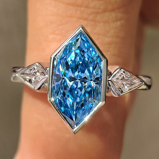 Three stone engagement ring with blue dutch marquise center diamond