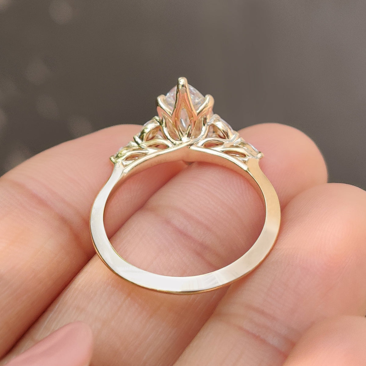 Marquise diamond ring with muse setting and side stones