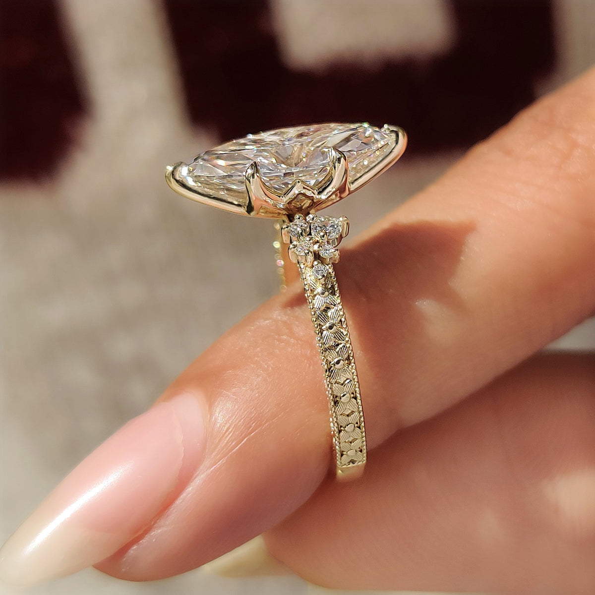Milgrain marquise diamond ring with round side stones